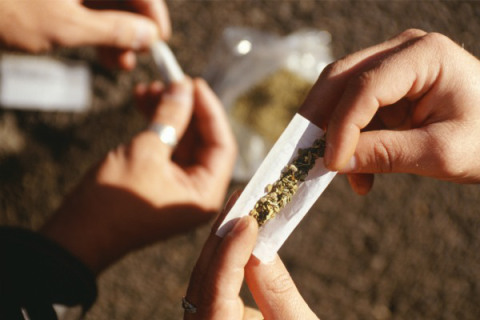 Kids preparing a marijuana joint