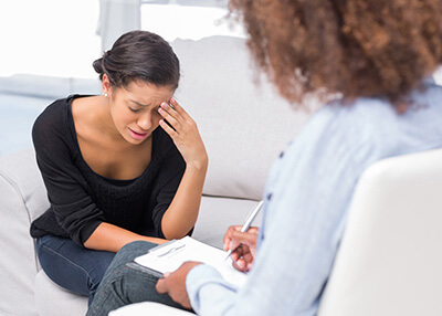 Therapy Insider - Depressed teenage girl in rehabilitation from substance abuse at therapeutic facility for youth