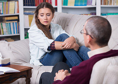 Therapy Insider - Sad teenage girl in rehabilitation from substance abuse at therapeutic facility for adolescents