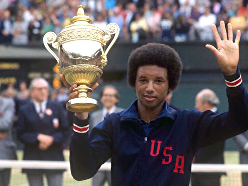 Arthur Ashe Holding Up Trophy