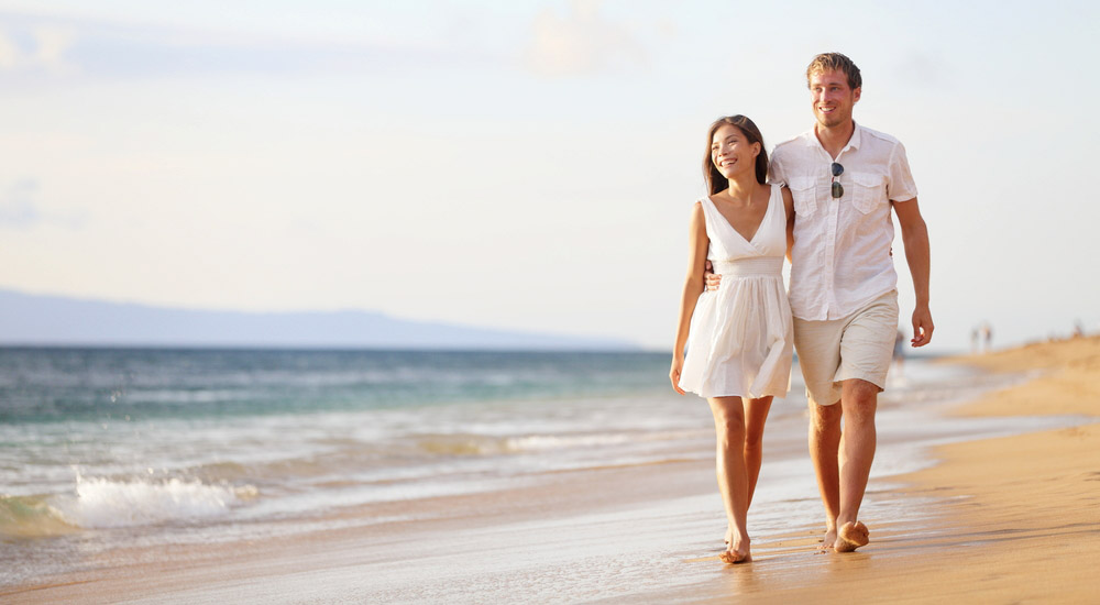 Happy couple walking on beach