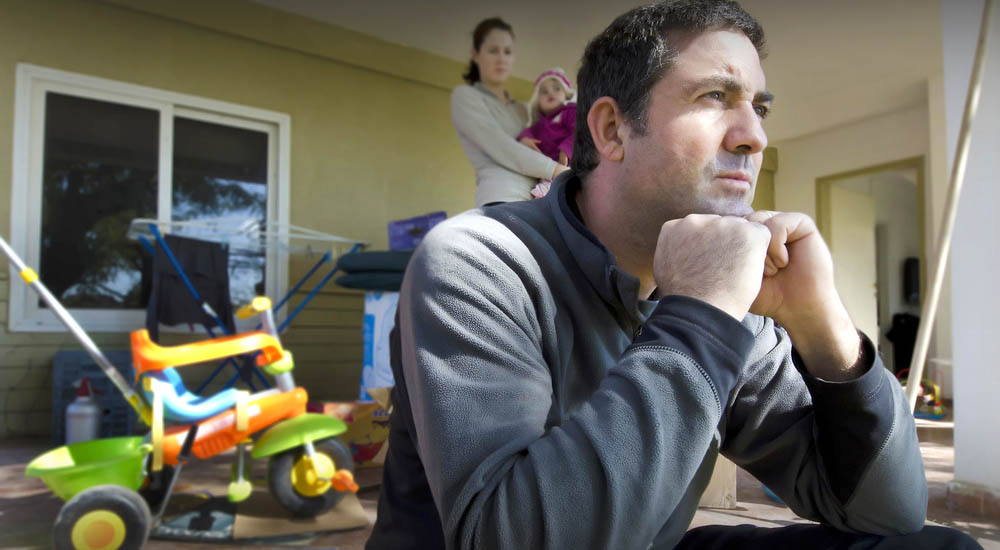 Stressed man sitting on patio